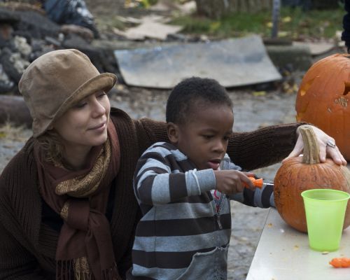 Young Boy Carving A Jack-O-Lantern