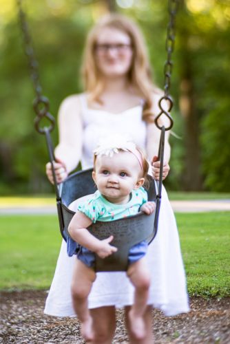 Mother and daughter playing on a swing